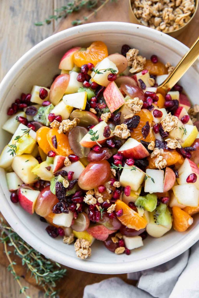 Thanksgiving fall fruit salad recipe in a bowl with a spoon.