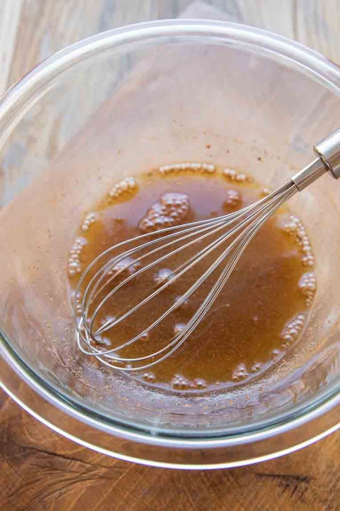 Fruit salad glaze being whisked in a bowl.
