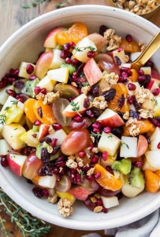 Thanksgiving fall fruit salad recipe in a bowl with a spoon.