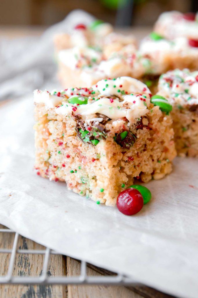 Close up of Christmas Rice Krispies Treat with white chocolate topping and holiday candy.