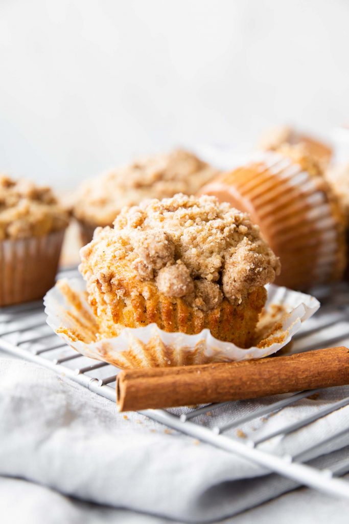 Across photo of Cinnamon Streusel Muffins with wrapper opened.