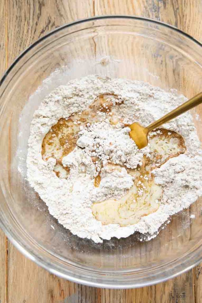 Melted butter in a bowl with dry ingredients.