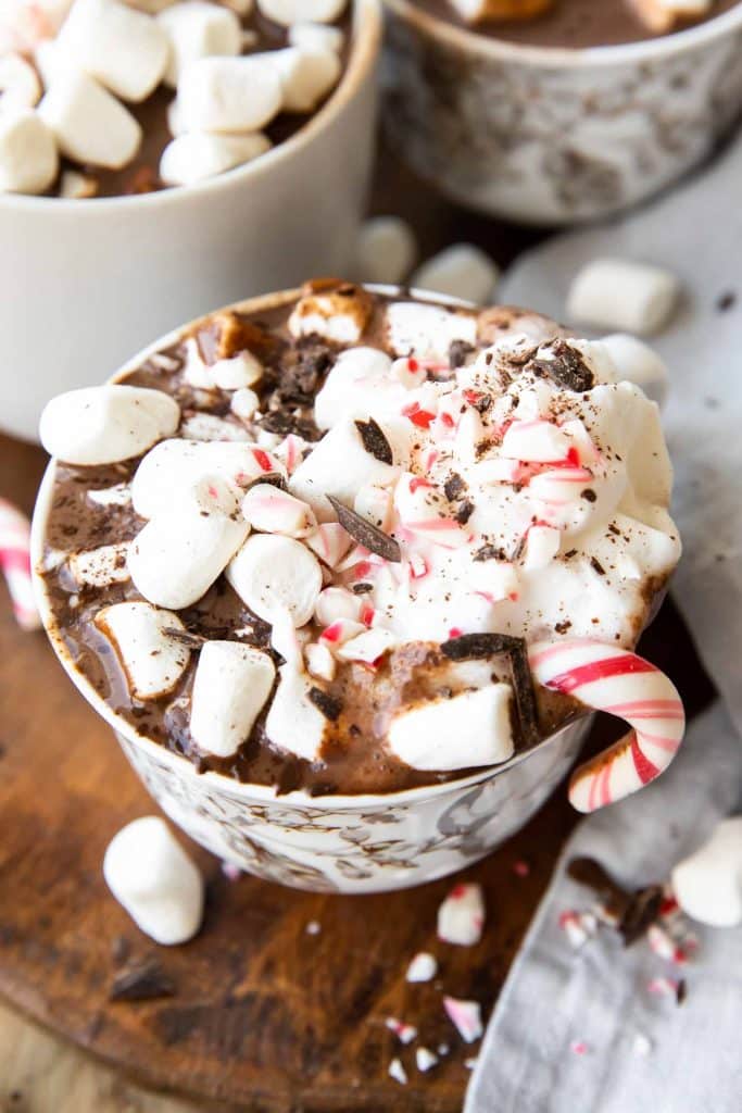 Crockpot Hot Chocolate in a mug with peppermint and marshmallows.