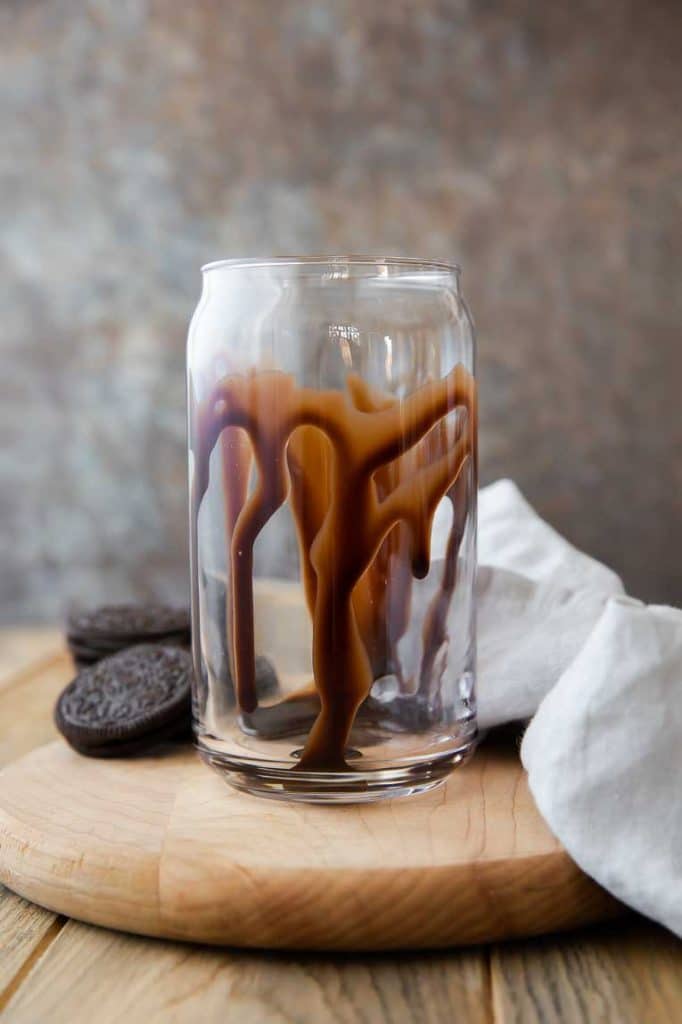 Chocolate drizzled into a glass cup.