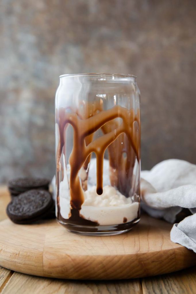 Layer of chocolate sauce and whipped cream on bottom of cup.