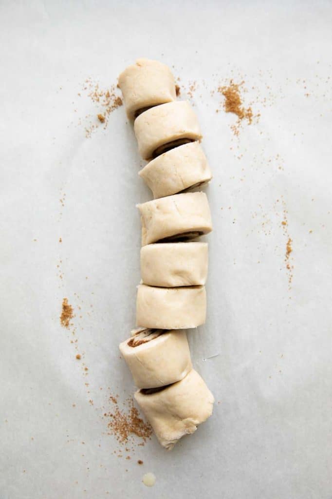 Cinnamon roll dough sliced.