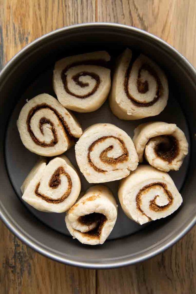 Cinnamon rolls in a small cake pan.