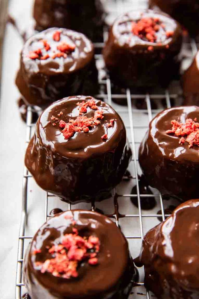 Freeze dried strawberries topping chocolate ganache cupcakes.