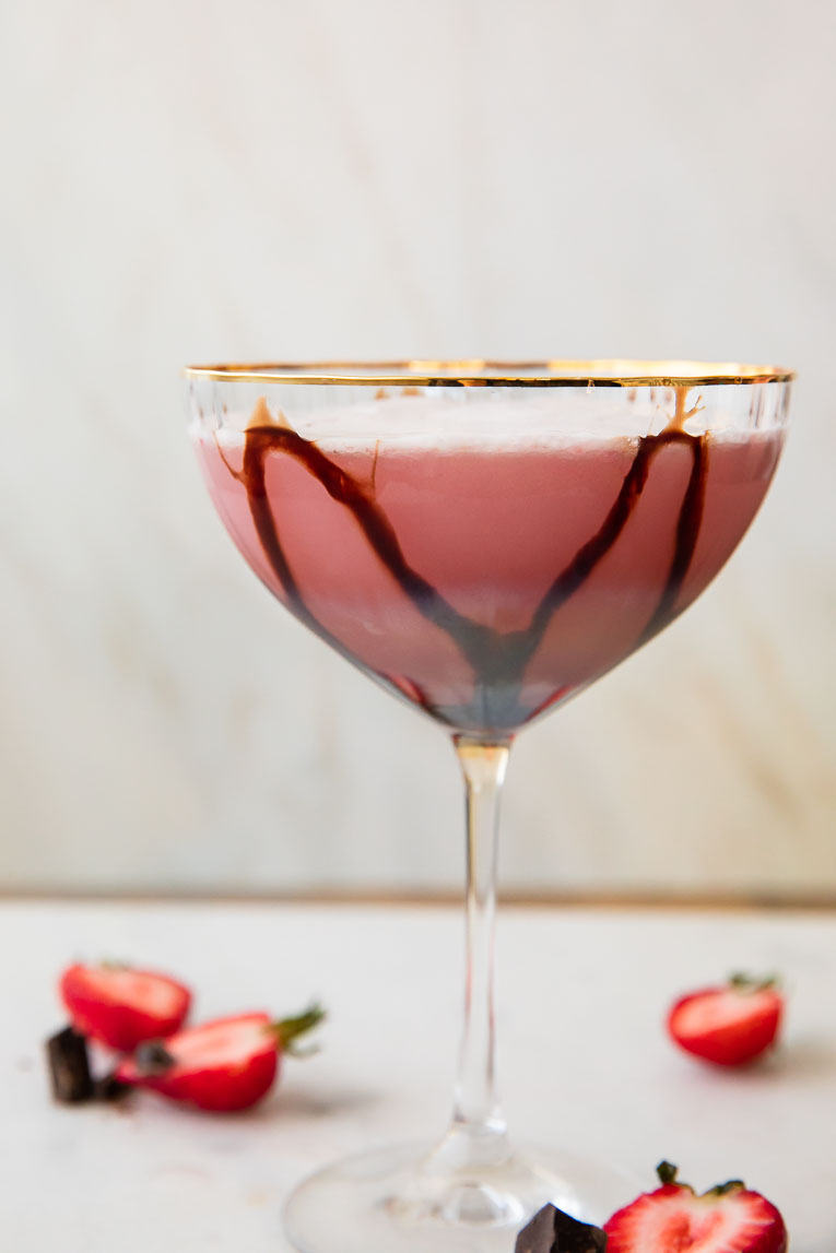 Valentine's Day Cocktail in a coupe glass with chocolate sauce.