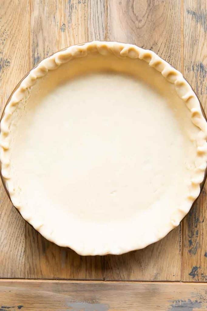 Empty pie crust in a pan.