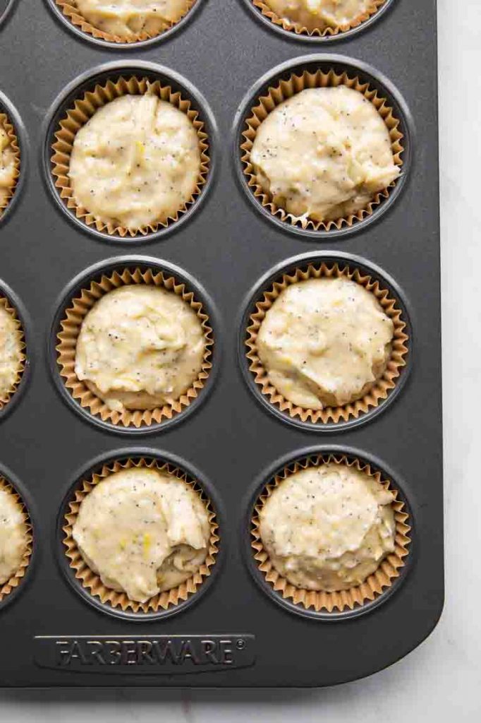 Lemon Poppy Seed Muffins batter in a muffin tin with liners.