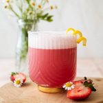 Pink Gin Sour cocktail with lemon.