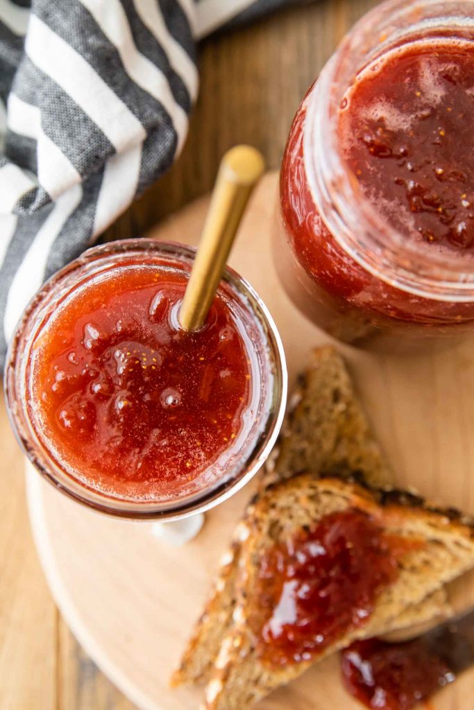 Strawberry Rhubarb Jam in mason jars and on bread.
