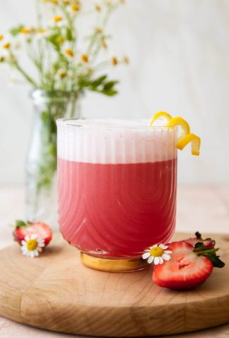 Pink Gin Sour cocktail with lemon.