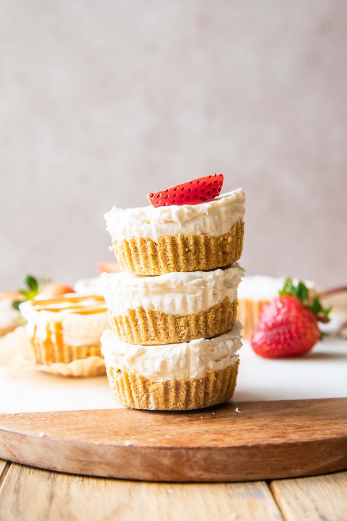 Stacked No-Bake Mini Cheesecake Bites with strawberries.