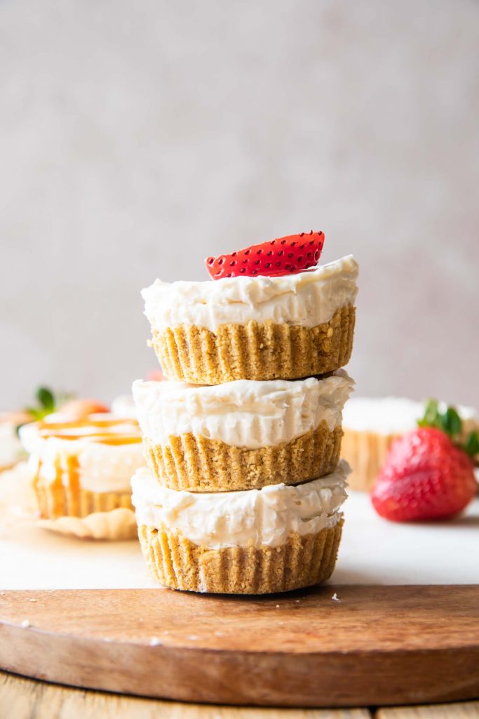Close up of No-Bake Mini Cheesecake Bites stacked on each other.