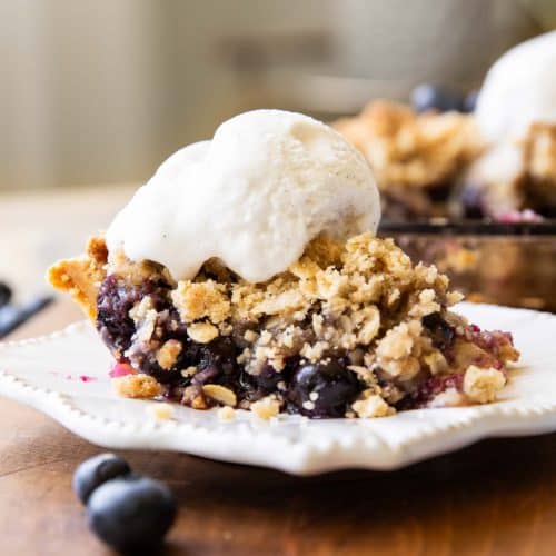 Slice of Blueberry Crumble Pie on a plate.