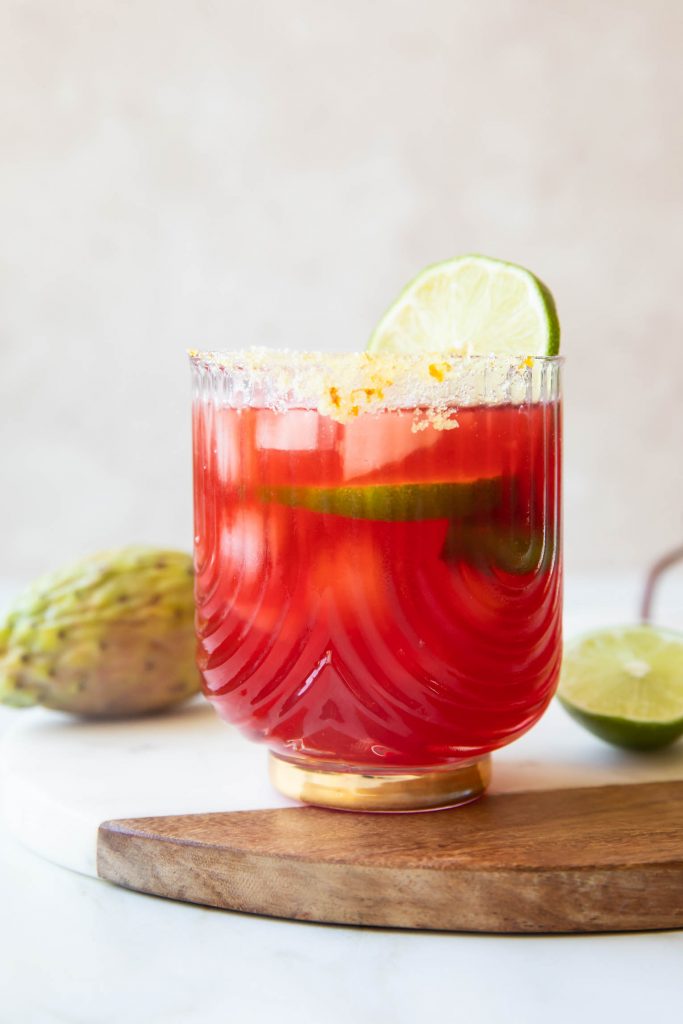 Prickly Pear Margarita recipe with lime wedge.
