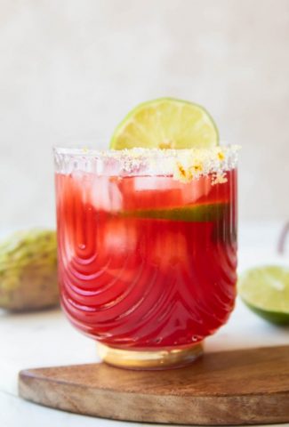 Prickly Pear Margarita recipe in a glass with lime.