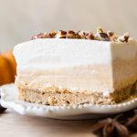 Close up of layered pumpkin dessert on a plate.