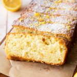 Sliced Lemon Olive Oil Cake with powdered sugar on top.