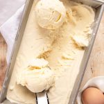 Homemade Ice Cream in a loaf pan with a scoop.
