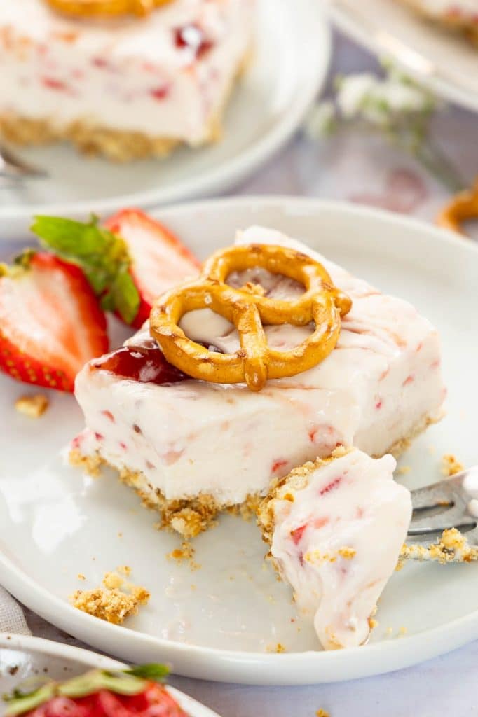 Bite taken out of Strawberry cream cheese Dessert.