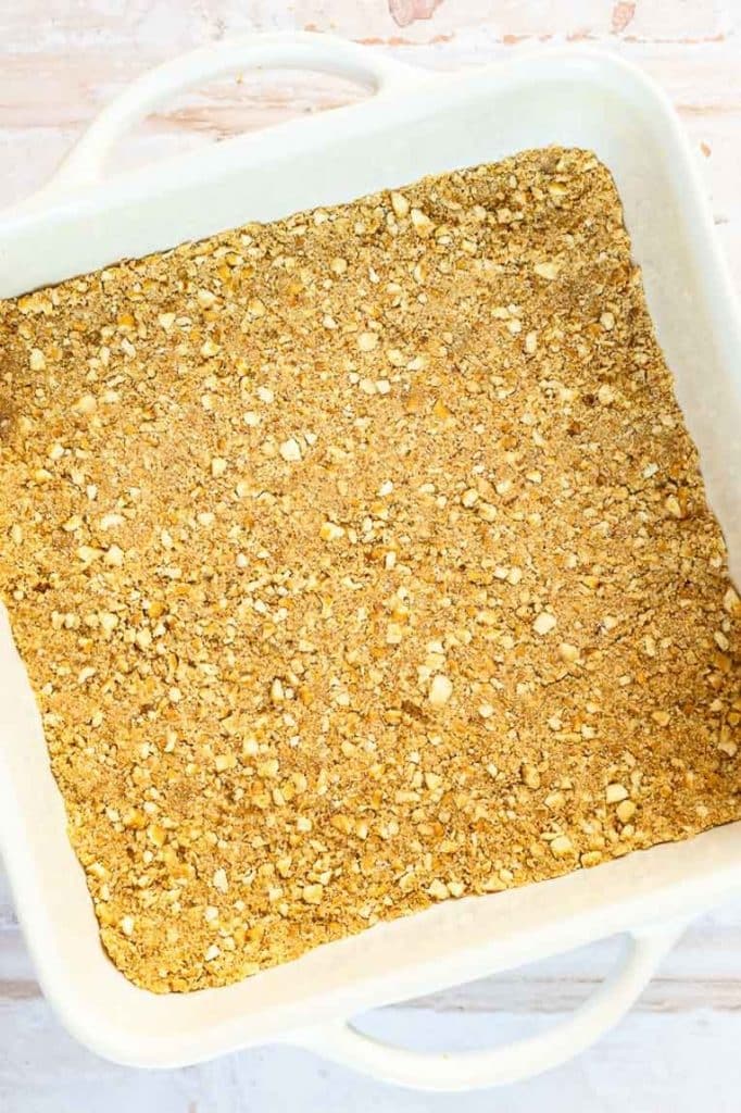Pretzel crust for summer dessert in a baking pan.