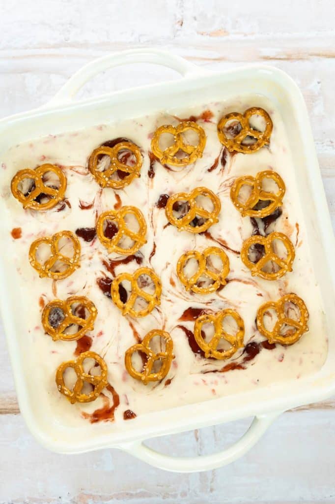 Strawberry Pretzel Dessert topped with mini pretzels for frozen bars.