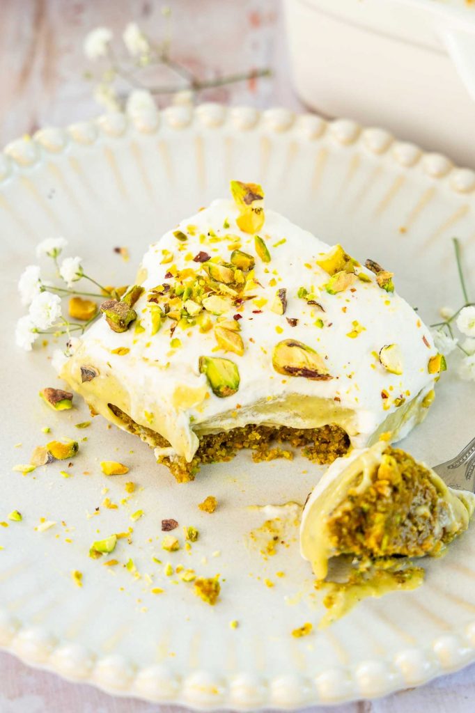 Pistachio Dessert on a plate with a bite taken out.