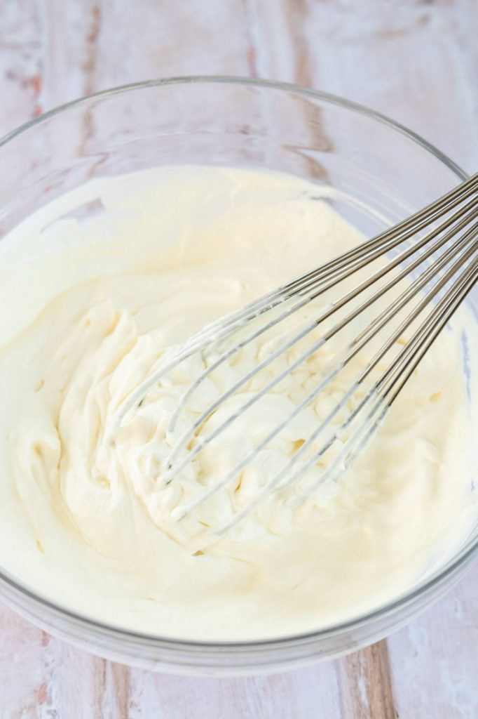 Whipped cream being whisked.