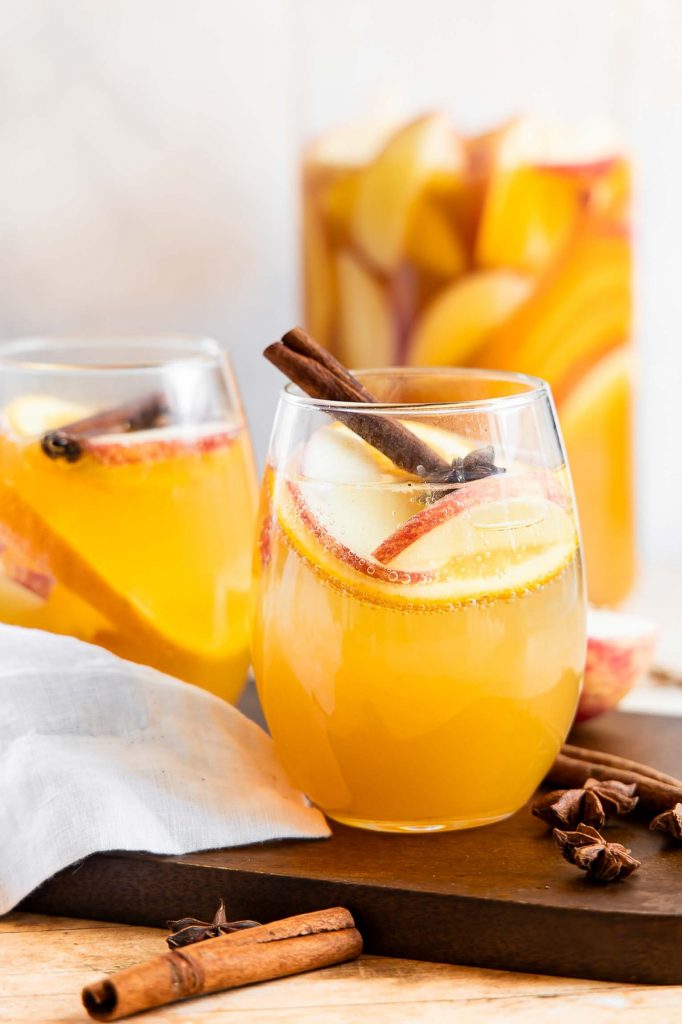 Two glasses and a pitcher of Apple Cider Sangria.