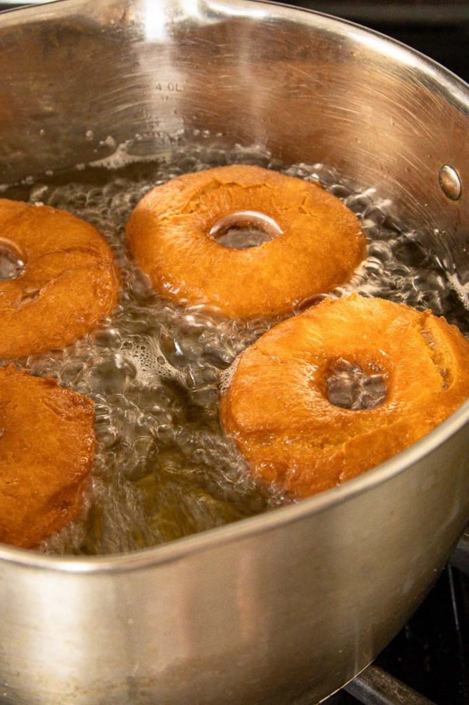 Cake donuts being fried.
