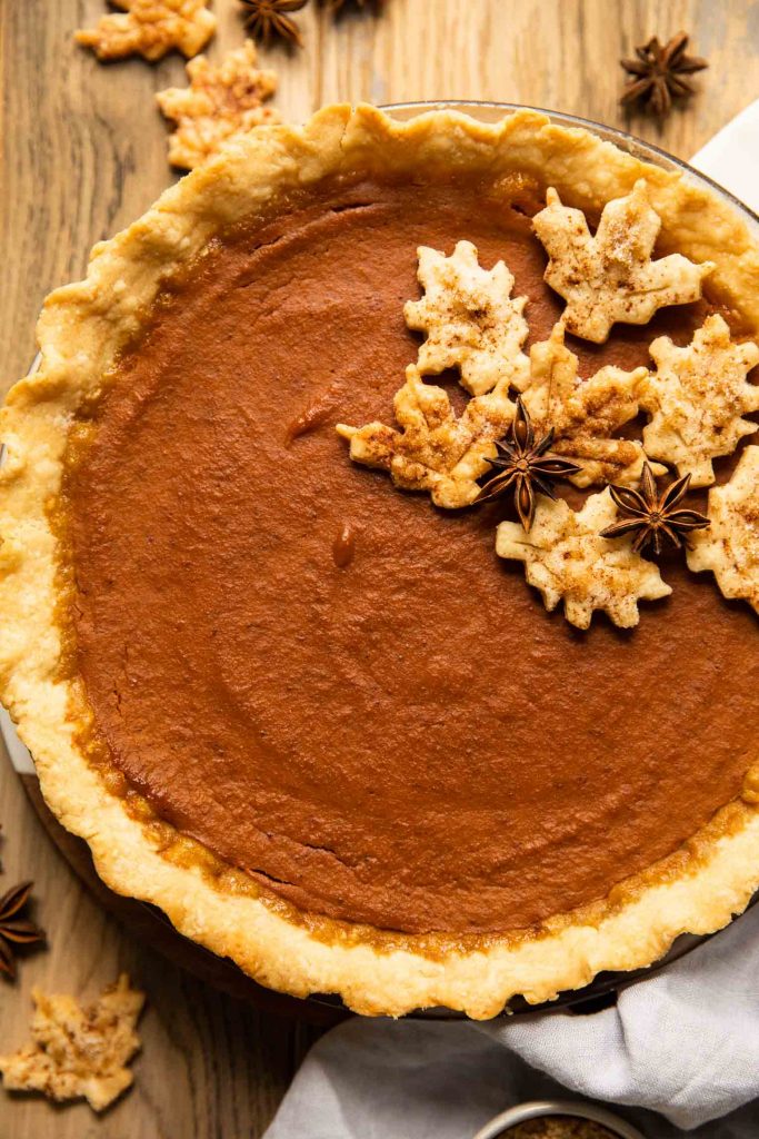 Pumpkin pie on a wooden surface.