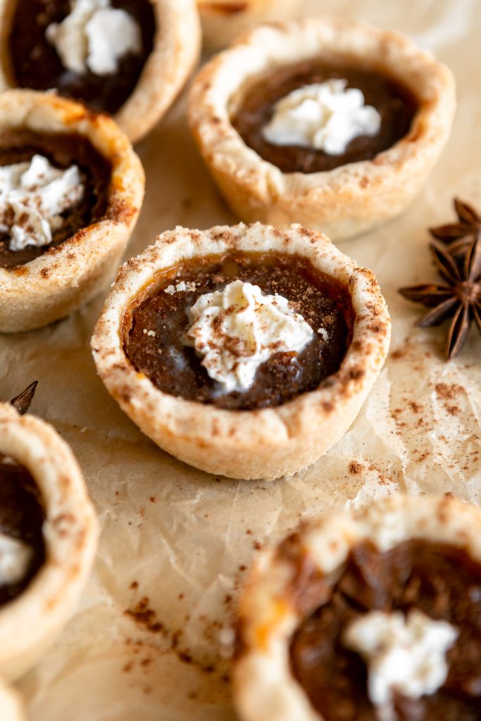Mini pumpkin pies on parchment paper.