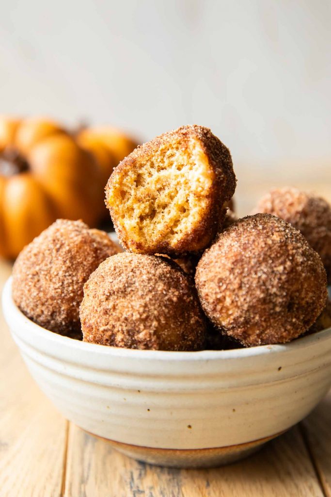 Pumpkin donut bites in a bowl.