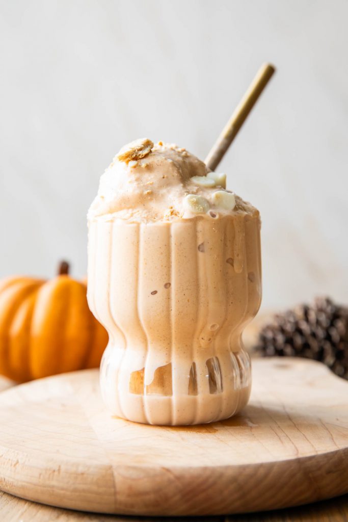 Pumpkin ice cream in a glass cup.