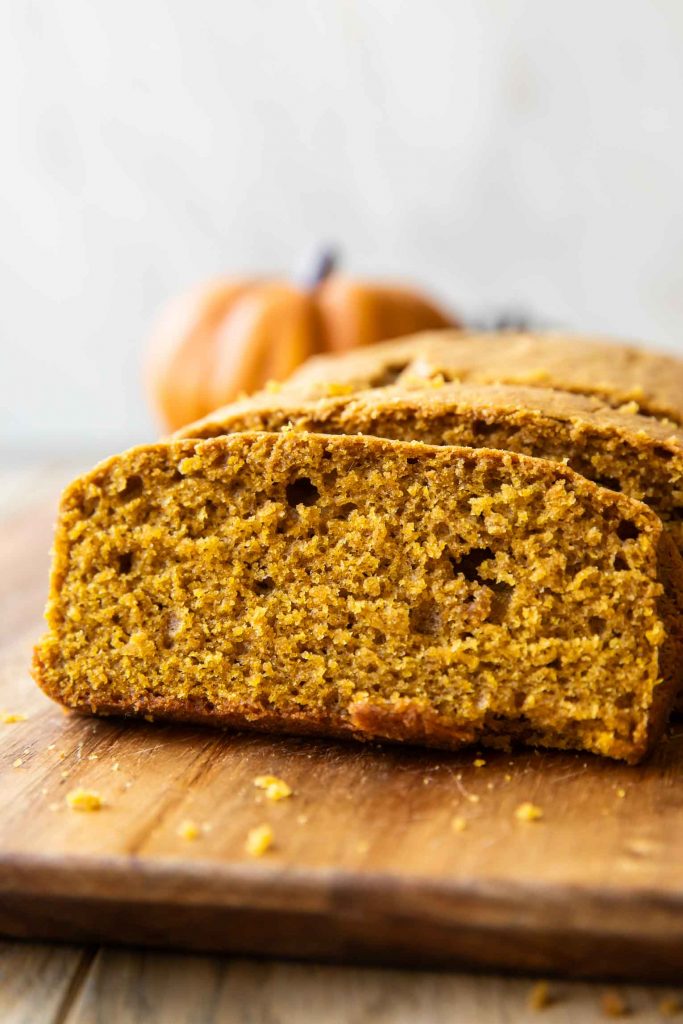 Pumpkin olive oil cake on a wooden surface.