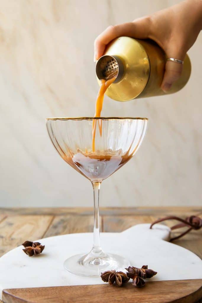Espresso Martini being poured into glass.