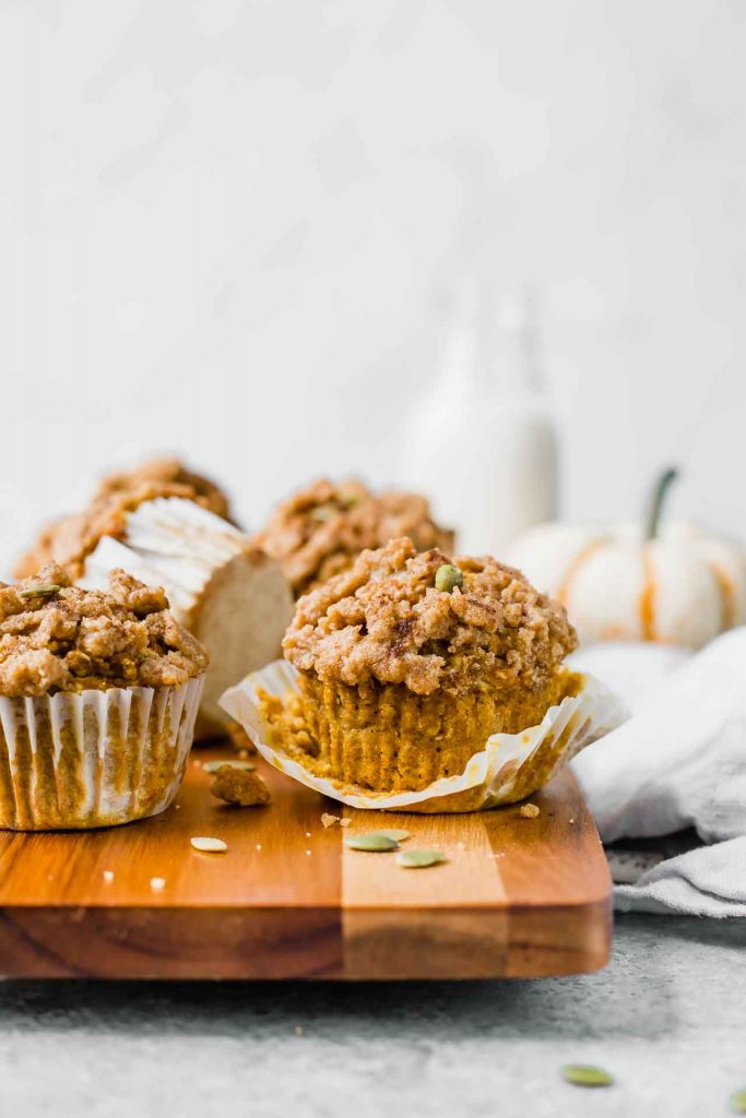 Pumpkin muffins on a cutting board.