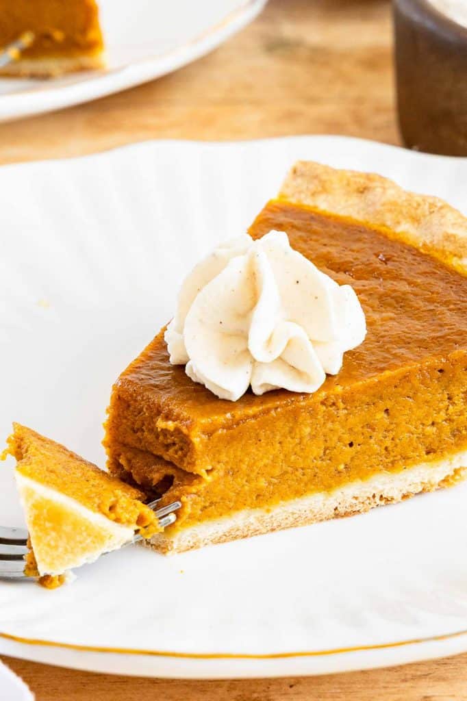 Pumpkin pie slice with fork.