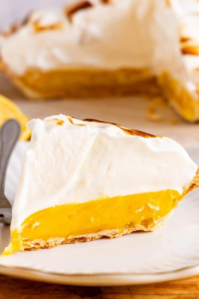 A slice of Lemon Meringue Pie on a plate.