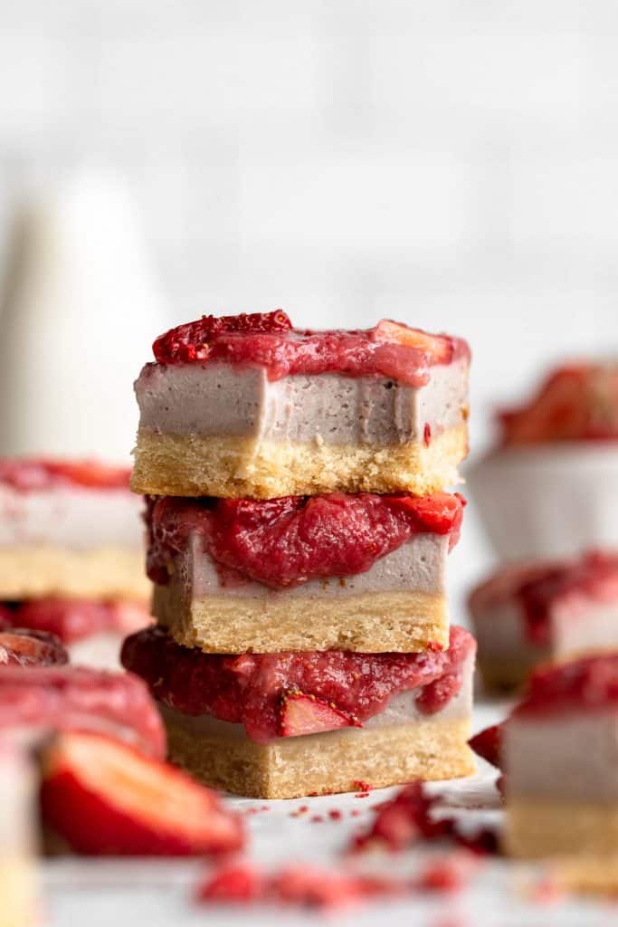 Strawberry Cheesecake Bars stacked on top of each other.