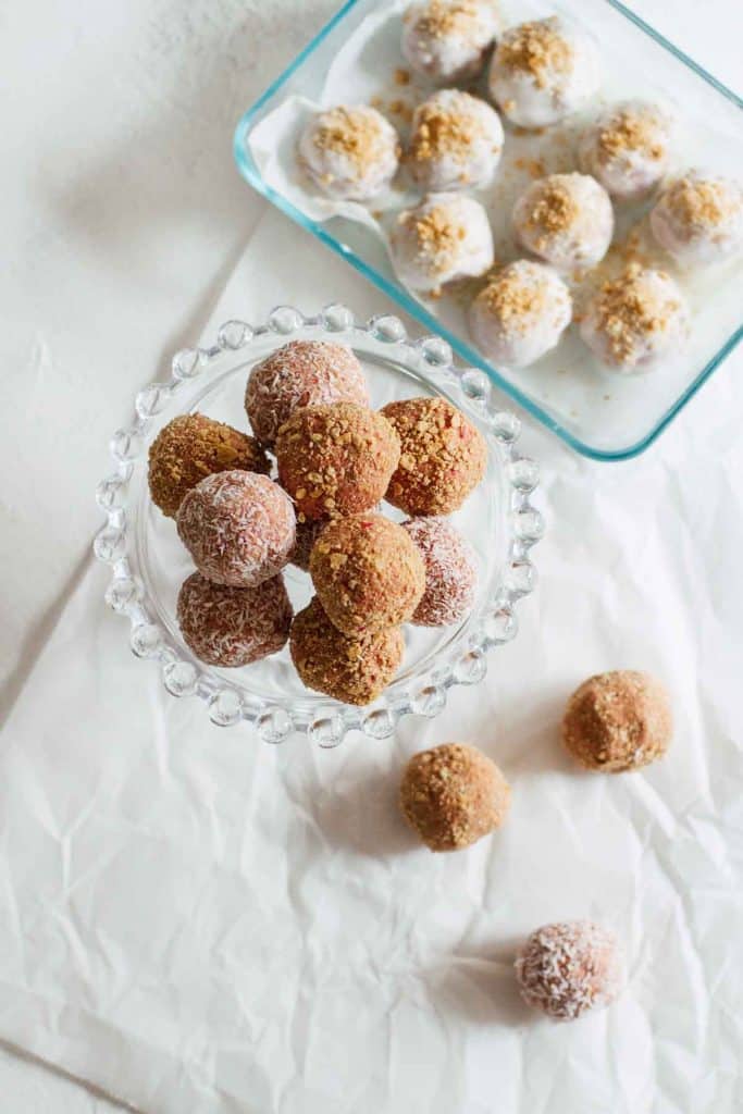 Strawberry cheesecake bites on parchment paper.