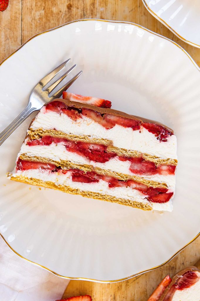 A slice of strawberry icebox cake on a plate.