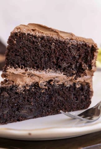 Slice of chocolate zucchini cake on a plate.