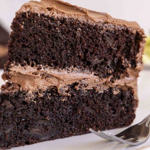 Slice of chocolate zucchini cake on a plate.