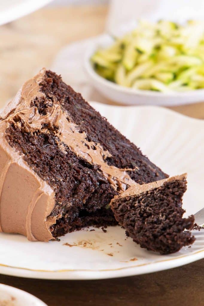 Slice of chocolate zucchini cake on a plate.