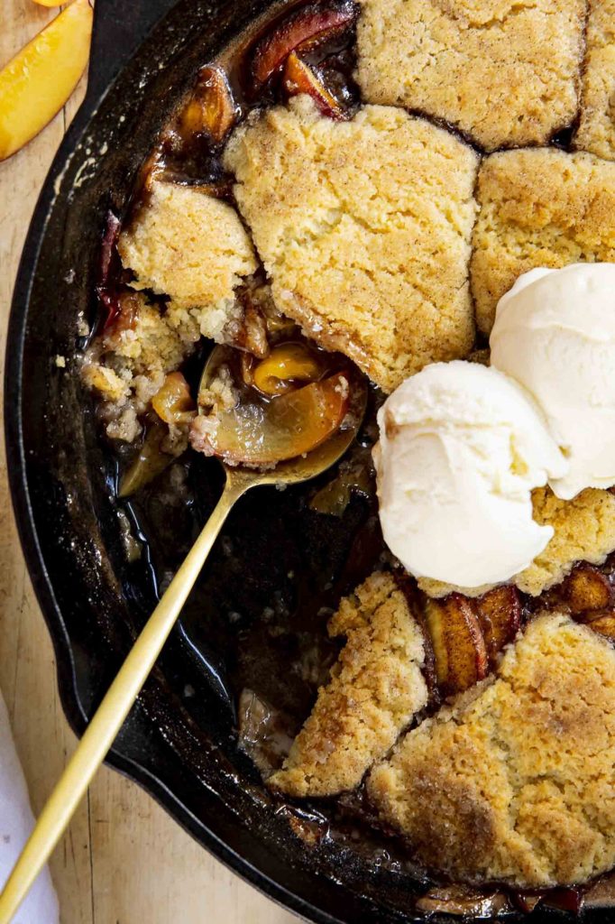 Peach cobbler in a skillet.