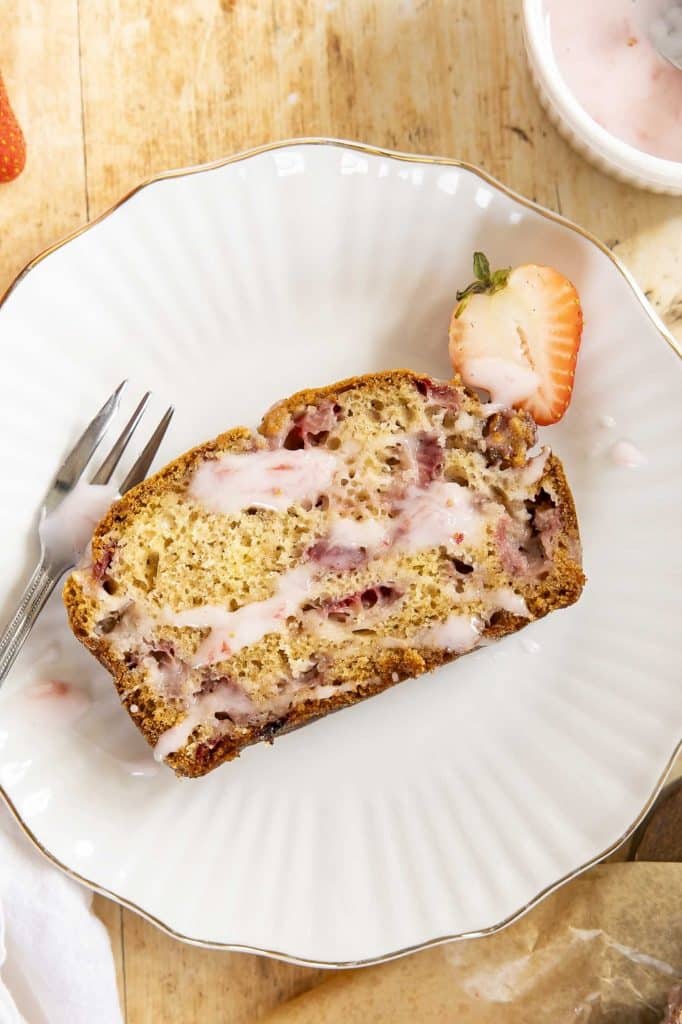 A slice of strawberry bread on a plate.